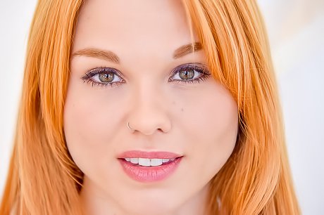 Redheaded beauty with a landing strip fucks herself with a glass toy